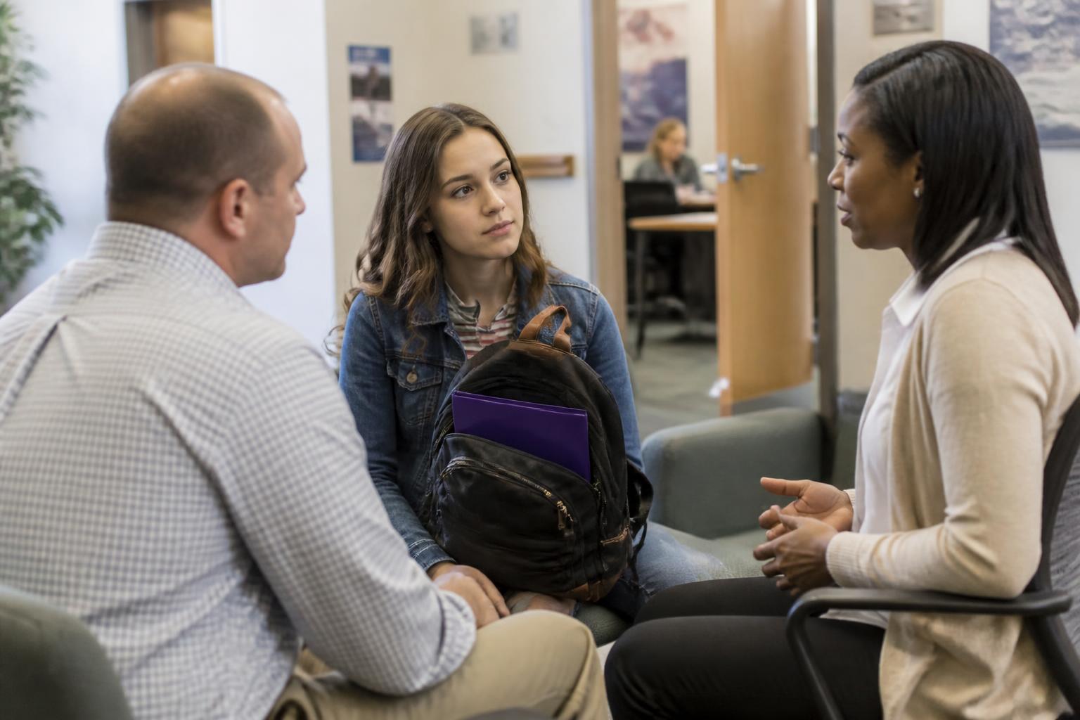 A student and parent meeting with a financial-aid counselor.
