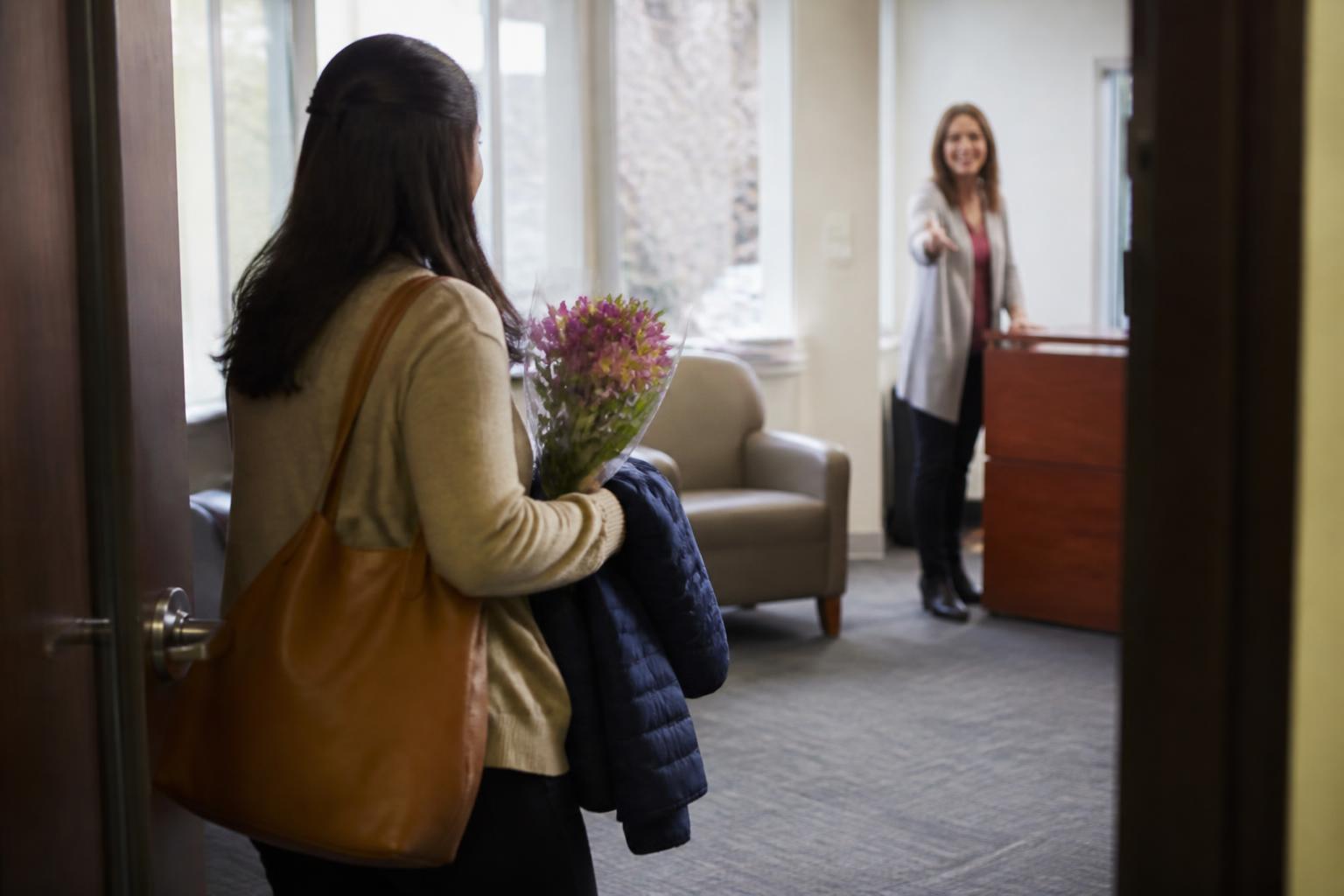 A parent entering an insurance appointment during Mother's Day week.