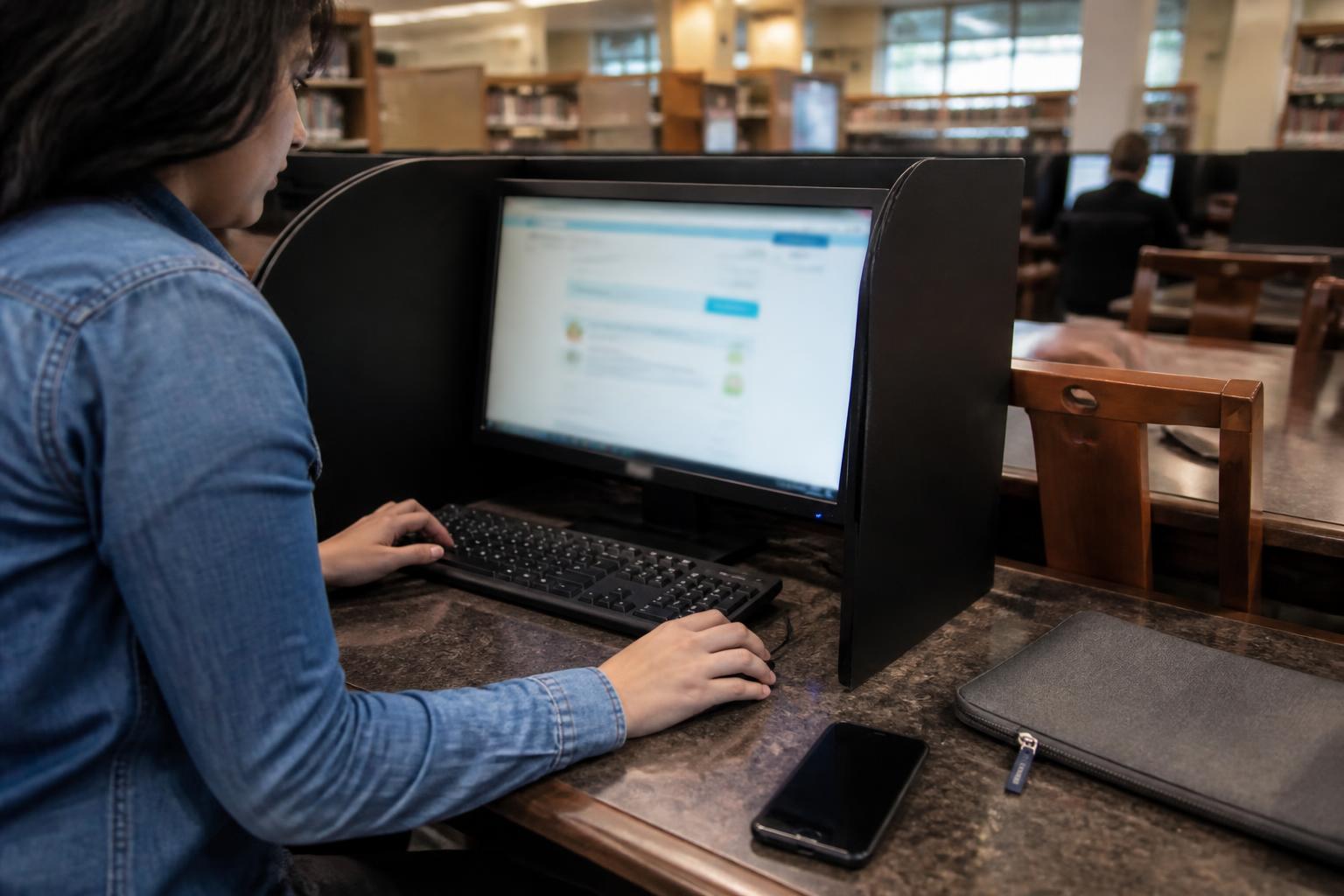 A consumer using a privacy-screen library computer after a data breach.