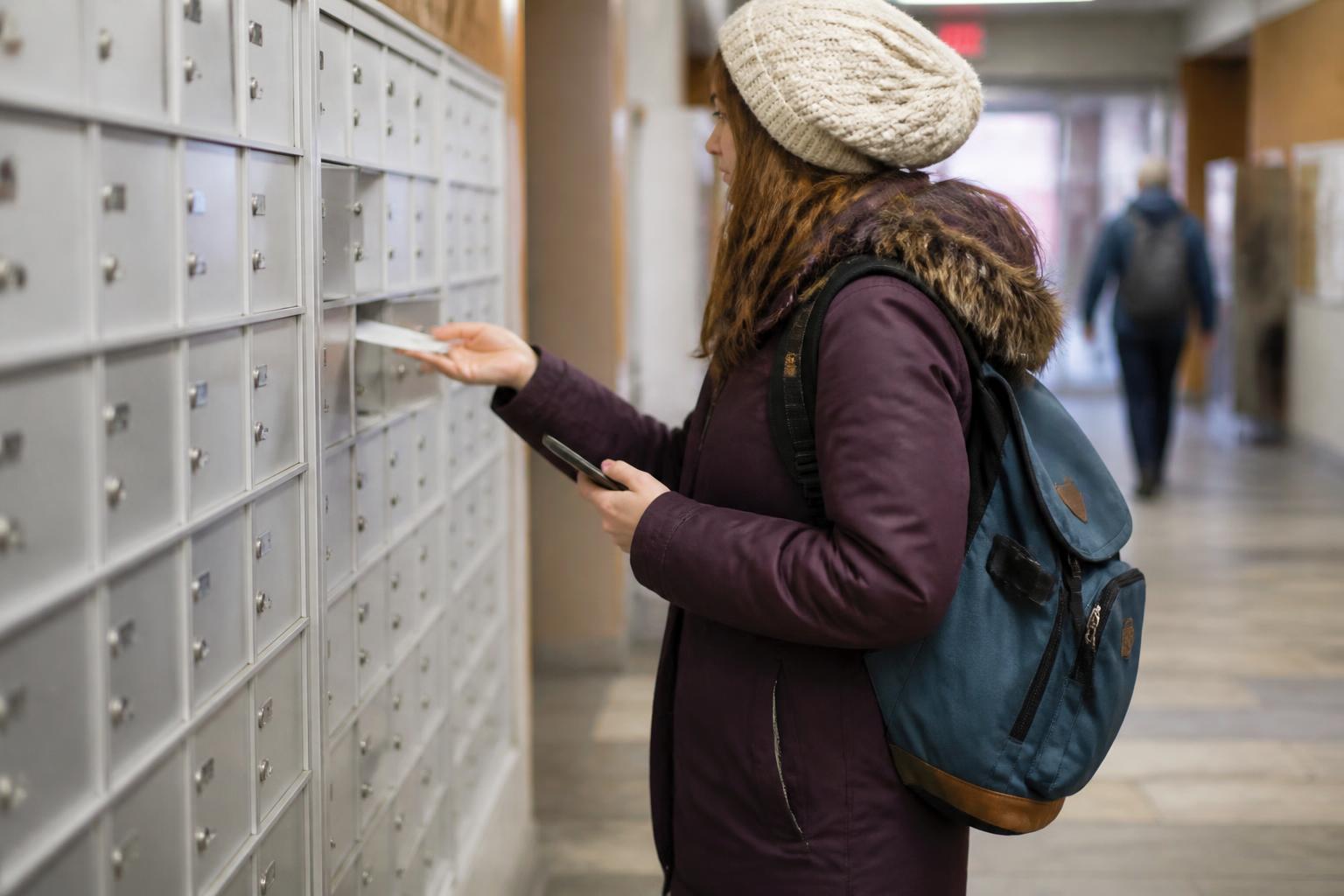 A borrower checking campus mail while adding a loan reminder.
